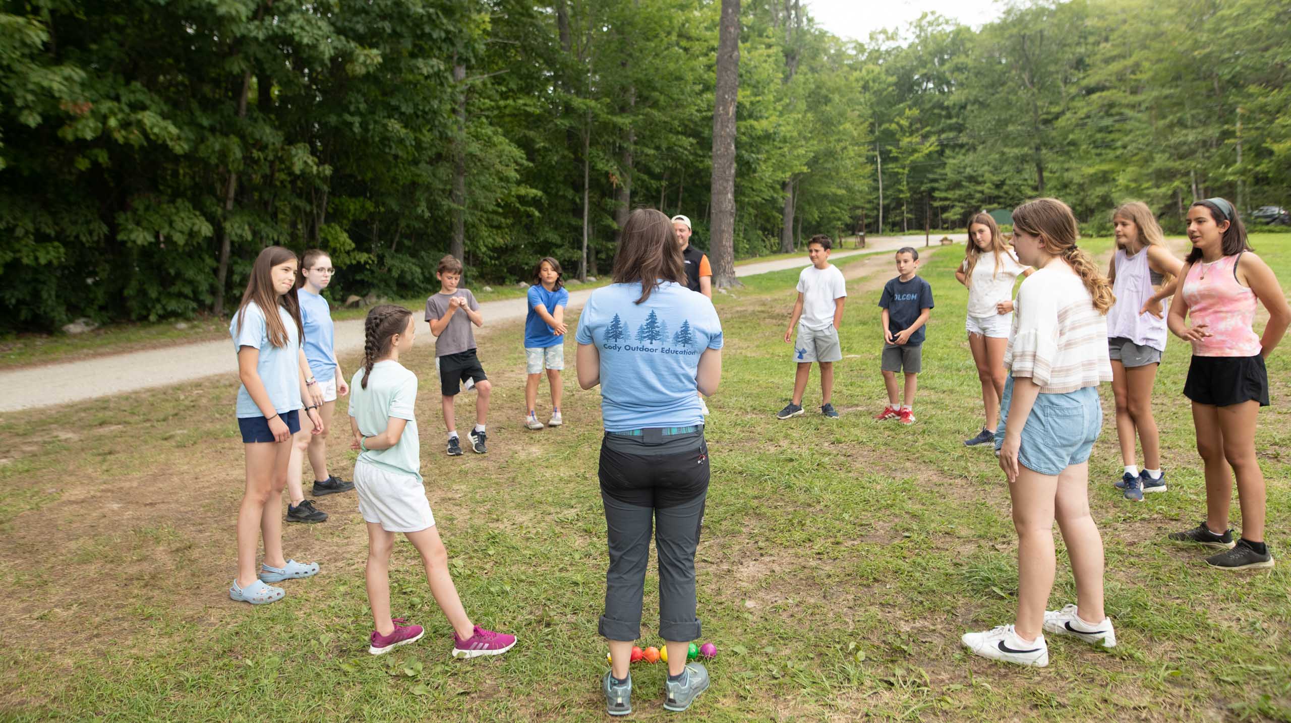 Instructor with kids in circle.