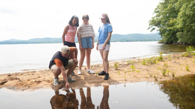 Kids standing by water.